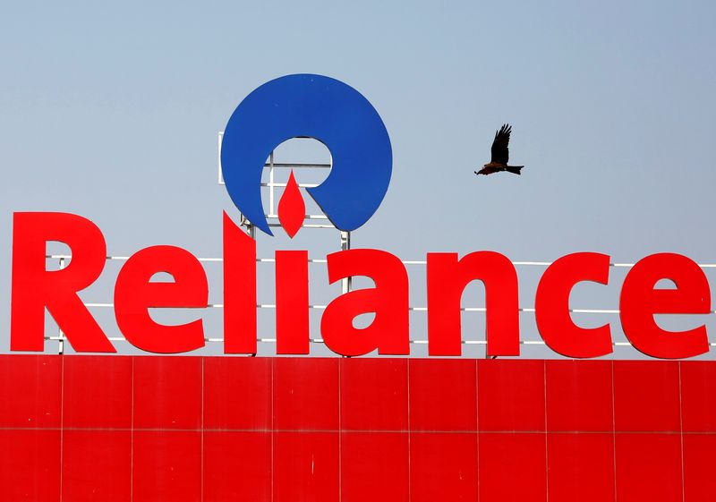 A bird flies past a Reliance Industries logo installed on its mart in Ahmedabad, India January 16, 2017. u00e2u20acu201d Reuters pic