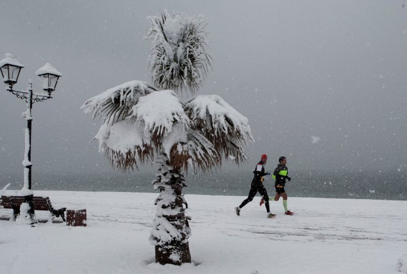 Men run along an embankment under a heavy snow fall in Sochi, Russia, January 29, 2017. u00e2u20acu201d Reuters pic