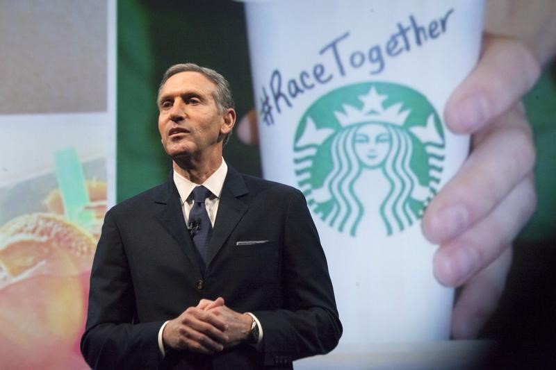 Starbucks Corp Chief Executive Howard Schultz, pictured with images from the company's new 'Race Together' project behind him, speaks during the company's annual shareholder's meeting in Seattle, Washington March 18, 2015. u00e2u20acu201d Reuters pic