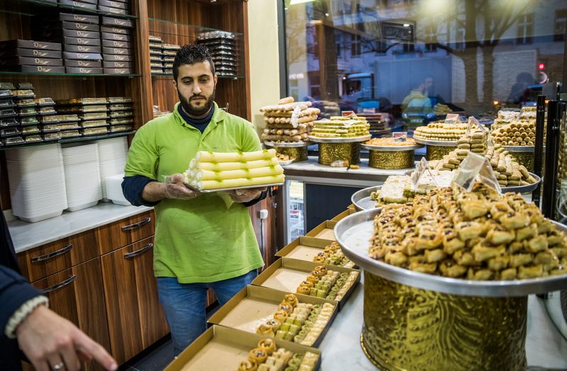 An employee seen working in the 'Konditorei Damaskus' pastry shop in the Neukoeln neighbourhood of Berlin January 12, 2017. u00e2u20acu201d Reuters pic 