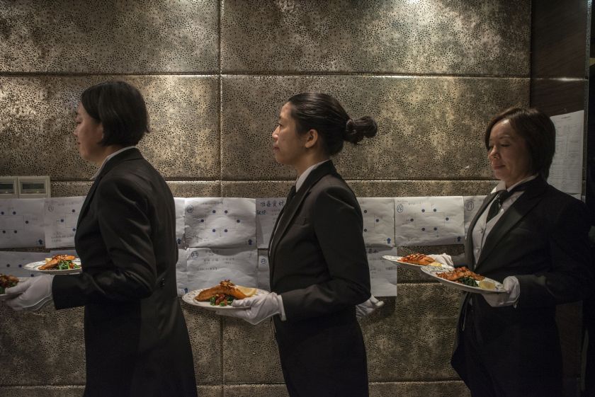 Students at the International Butler Academy China wait to bring a dish of fried salmon during a dinner exam Chengdu November 28, 2016. — Picture by Gilles Sabrie/The New York Times 
