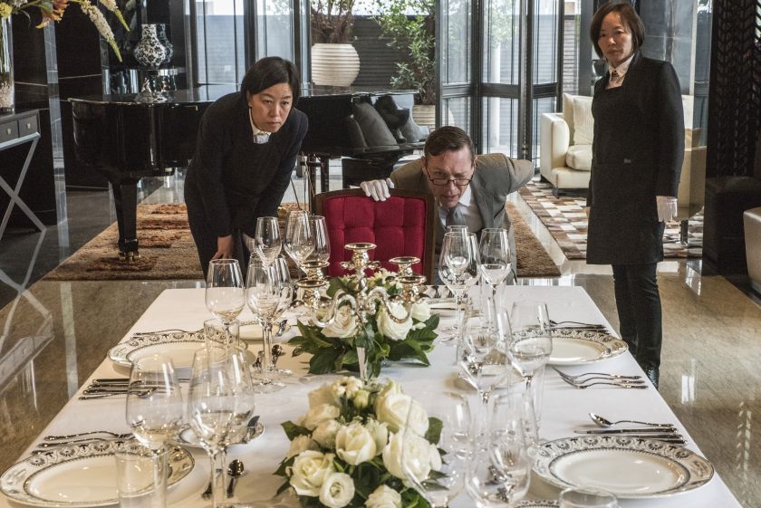 Christopher Noble (centre) an instructor at the International Butler Academy China, checks the alignment of glasses on the table in Chengdu November 28, 2016. — Picture by Gilles Sabrie/The New York Times 