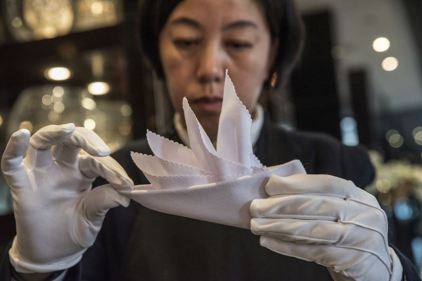 Liu Janmin, a student at the International Butler Academy China, folds a napkin for formal dinner in Chengdu November 28, 2016. — Picture by Gilles Sabrie/The New York Times 