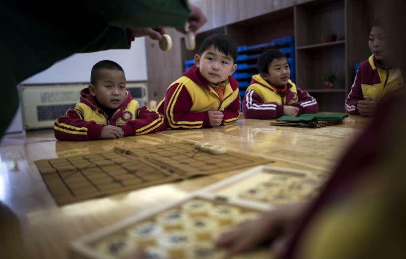 Boys learn to play Chinese chess at a Confucius kindergarten in Wuhan February 2, 2016. u00e2u20acu201d AFP pic
