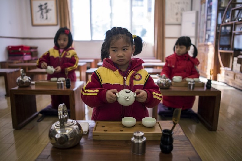 Girls learn to perform a tea ceremony at a Confucius kindergarten in Wuhan February 2, 2016. — AFP pic