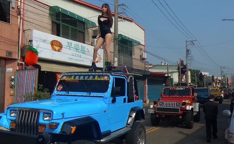 Pole dancers perform on top of jeeps during the funeral procession of former Chiayi City county council speaker Tung Hsiang in Chiayi City, southern Taiwan, January 3, 2017. u00e2u20acu201d AFP pic