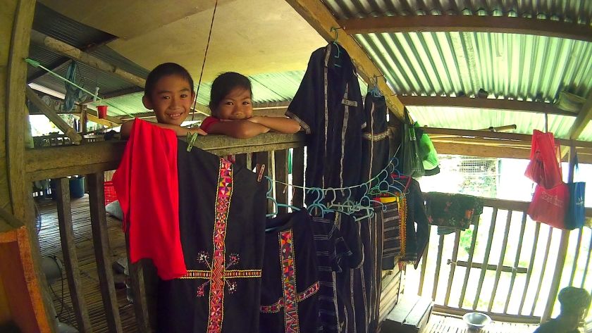 Children of the Monungkus members in a Rungus home in Kampung Inukiran, Kudat watch on while their elders fashion the products of their ancestors. — Picture by Julia Chan 