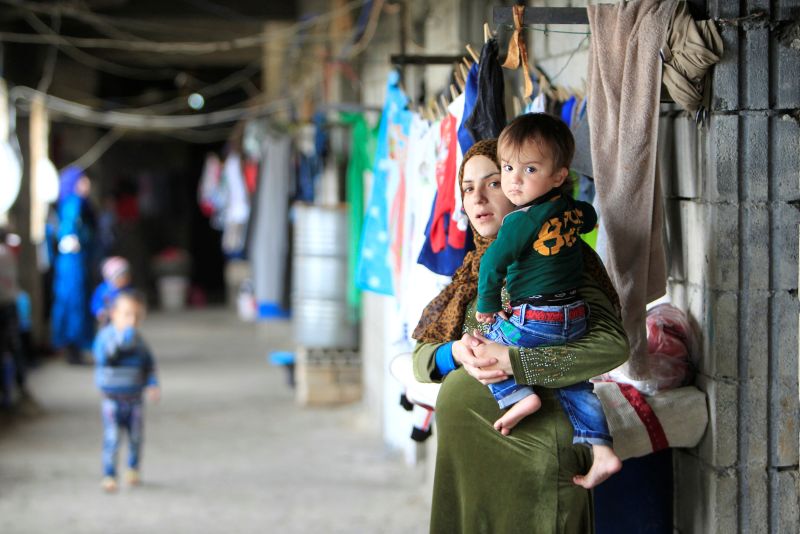 A pregnant Syrian woman carries her child at a compound housing Syrian refugees in Sidon, southern Lebanon January 25, 2017. u00e2u20acu201d Reuters pic
