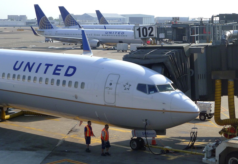 Two ground crew members walk past a United Airlines airplane as it sits at a gate at Newark Liberty International Airport in Newark, New Jersey, June 18, 2011. u00e2u20acu201d Reuters pic 