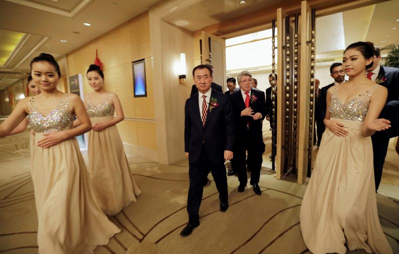 Wang Jianlin (left), chairman of Dalian Wanda Group, and Atletico Madrid's President Enrique Cerezo arrive for a signing ceremony in Beijing, January 21, 2015. u00e2u20acu2022 Reuters pic