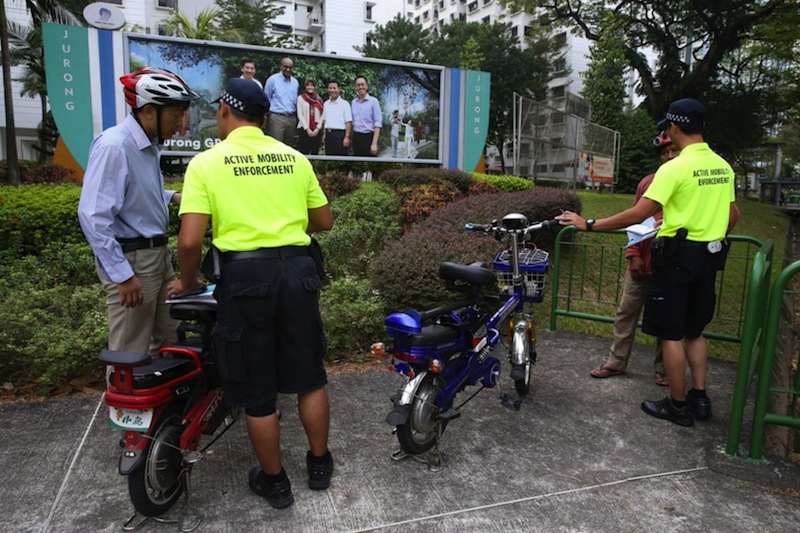 Active mobility enforcement officers seen checking on a personal mobility devices along Yung Seng Road. u00e2u20acu201d TODAY pic
