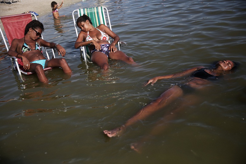 Women relax at an artificial pond known as piscinao, or big pool, in the northern suburbs of Rio de Janeiro. 
