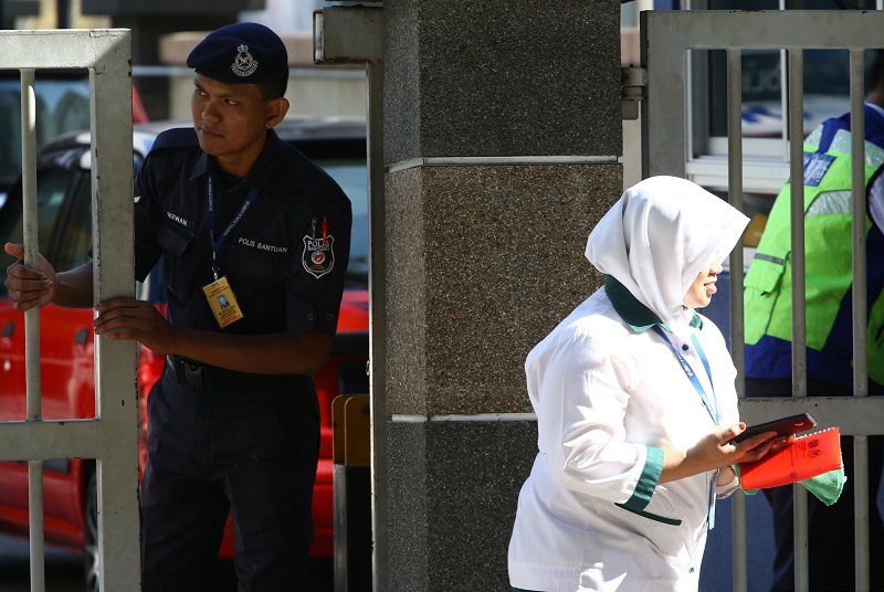 A police officer looks on as a hospital staff walks past outside the morgue at Kuala Lumpur General Hospital where Kim Jong-namu00e2u20acu2122s body is held for autopsy in Kuala Lumpur February 17, 2017. u00e2u20acu201d Reuters pic
