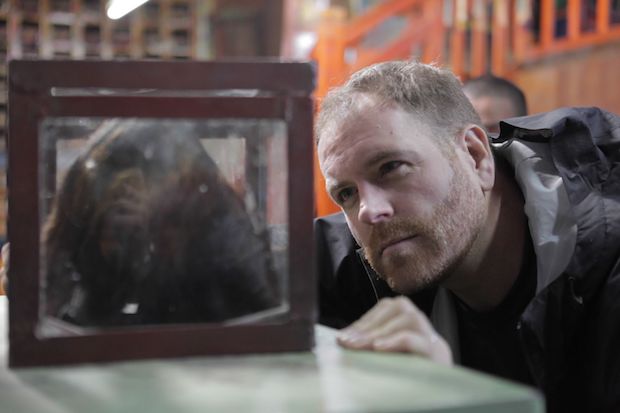 Josh Gates examining the Khumjung yeti scalp in Nepal while on the hunt for the yeti in Siberia. — Picture courtesy of Travel Channel