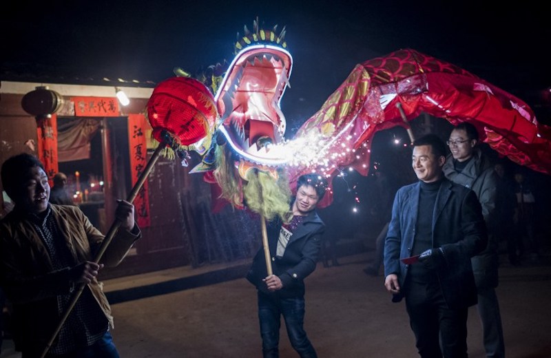 This picture taken on February 9, 2017 shows villagers parading a dragon through Peitian village, Liancheng county of China's eastern Fujian province. u00e2u20acu201d AFP pic