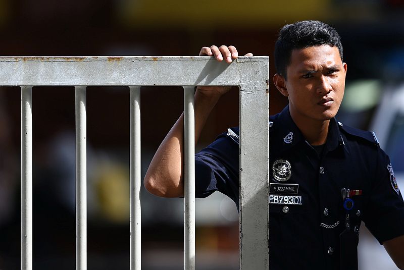 A police officer looks on as he stands at the gate of the morgue at Kuala Lumpur General Hospital where Kim Jong Nam's body is held for autopsy in Malaysia February 19, 2017.  u00e2u20acu201d Reuters pic
