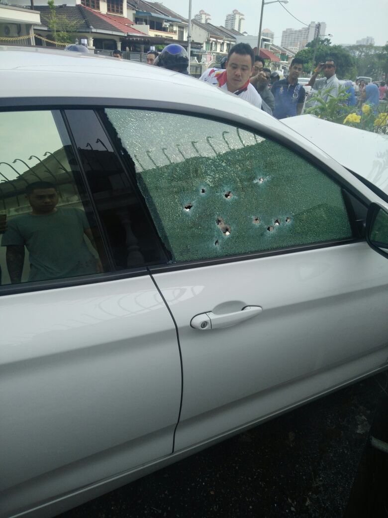 The driver’s window riddled with bullet holes. — Malay Mail pic