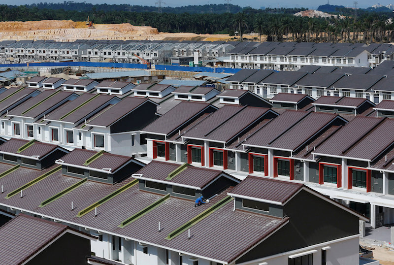 A labourer works on a residential construction site in Bukit Raja Klang, outside Kuala Lumpur July 4, 2014. u00e2u20acu201d Reuters pic
