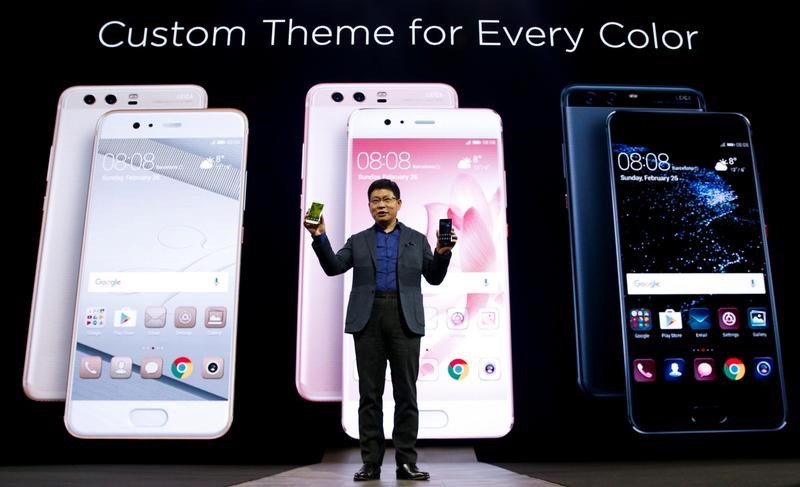 Richard Yu, chief executive of Huawei's consumer business, holds up new P10 devices during the presentation ceremony at Mobile World Congress in Barcelona February 26, 2017. u00e2u20acu201d Reuters pic