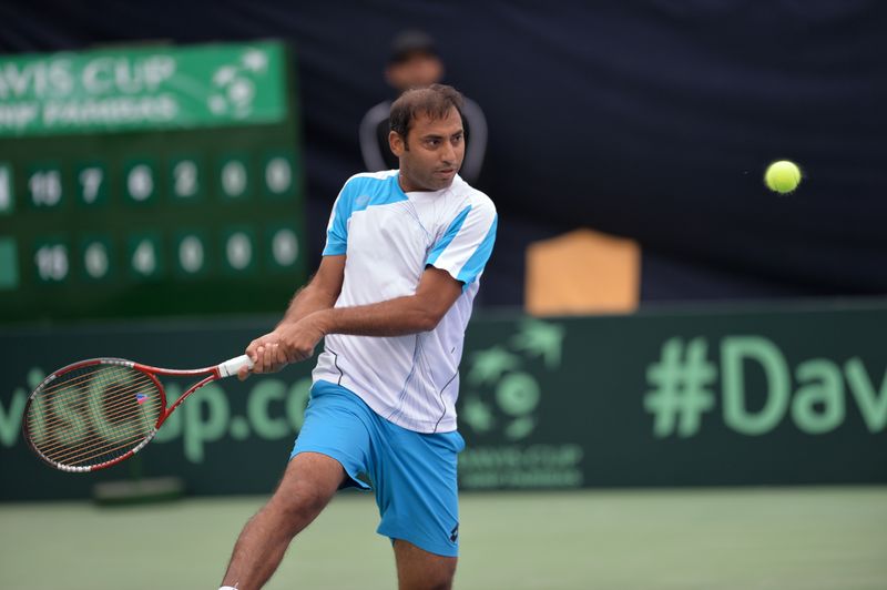 Aqeel Khan of Pakistan plays a return shot against Shahin Khaledan of Iran during their Davis Cup tennis group II match at the Sports Complex in Islamabad on February 3, 2017. u00e2u20acu201d AFP pic