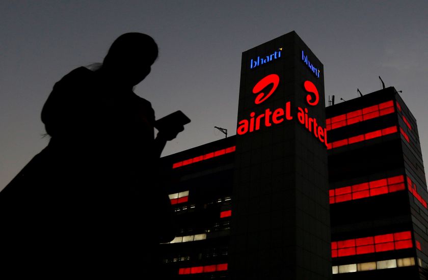 A girl checks her mobile phone as she walks past the Bharti Airtel office building in Gurugram, previously known as Gurgaon, on the outskirts of New Delhi in this picture released February 23, 2017. u00e2u20acu201d Reuters pic