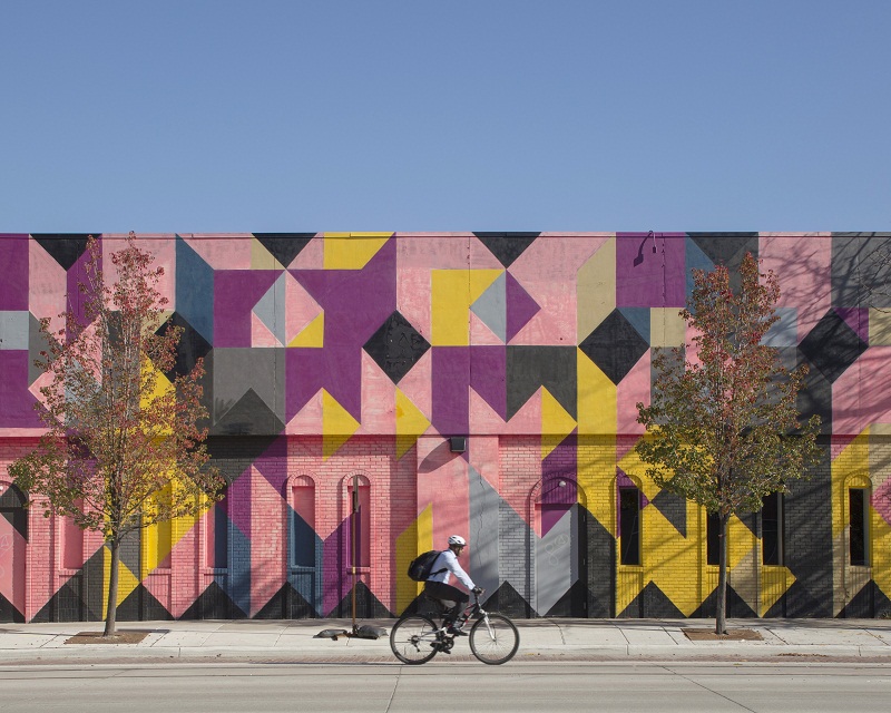 A cyclist passes Andrew Kuo’s colourful painting on exterior of the Museum of Contemporary Art in Detroit, November 7, 2016. — Picture by Kevin Miyazaki/The New York Times