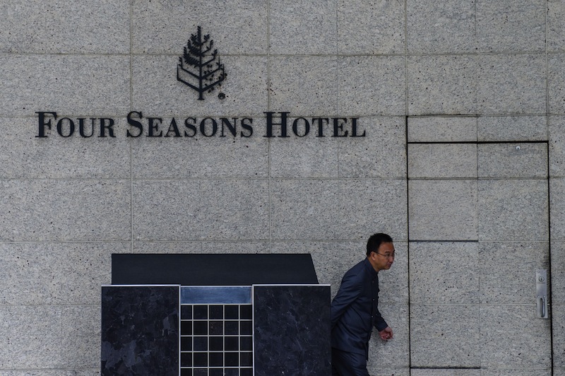 A member of staff walks outside the Four Seasons Hotel in Hong Kong on February 1, 2017. u00e2u20acu201d AFP pic