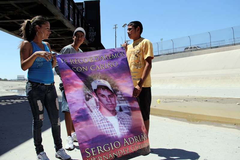 Relatives of late teenager Sergio Hernandez hold a banner with a picture of him under a railroad bridge connecting El Paso with Ciudad Juarez June 7, 2012. u00e2u20acu201d Reuters pic 