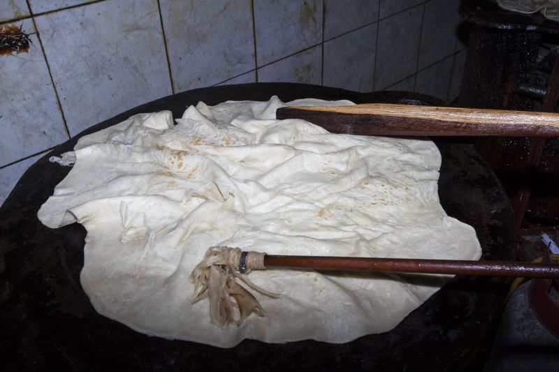 Roti is brushed with oil on the tawa, a large cast-iron griddle, at Pope Amin’s restaurant San Fernando, Trinidad and Tobago. 