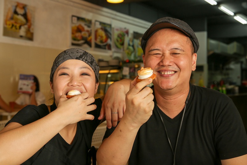 Eat the UFO tarts the Sabahan way, in one gulp as demonstrated by Debra Leong and Desonny Tuzan.