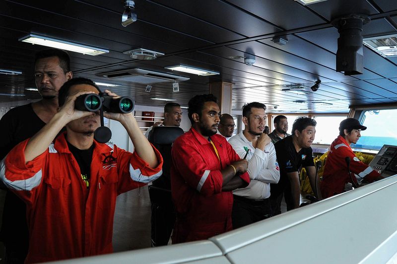 Ship captain Faisal Mohd Firdaus Mohamad with his crew reviews the situation aboard the Nautical Aliya in the Andaman Sea (Myanmar waters), February 7, 2017. u00e2u20acu201d Bernama pic