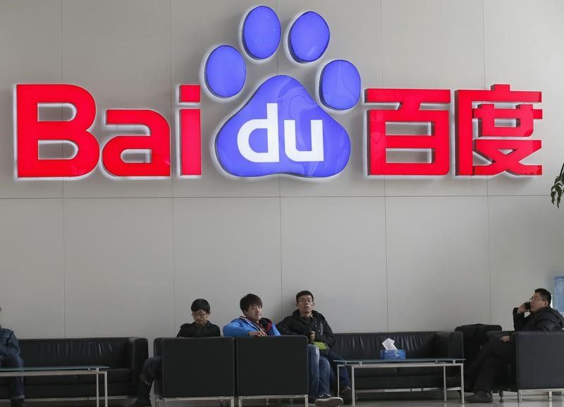People sit in front of the company logo of Baidu at its headquarters in Beijing. u00e2u20acu2022 Reuters pic
