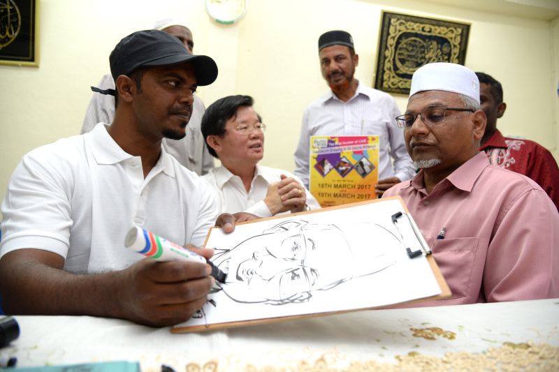 Mohd Azmi did a live demonstration of drawing a caricature in under three minutes. u00e2u20acu201d Picture by K.E.Ooi