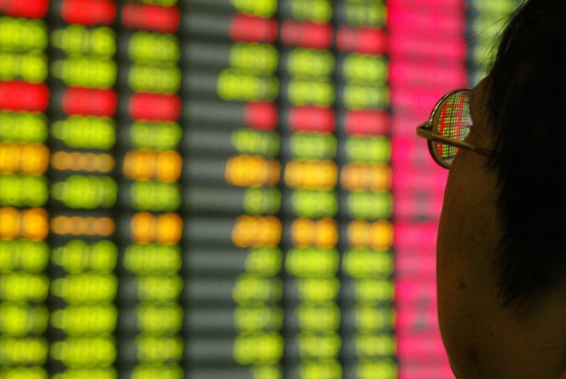 A Chinese investor monitors share prices at a securities company in Shanghai. u00e2u20acu2022 Reuters pic