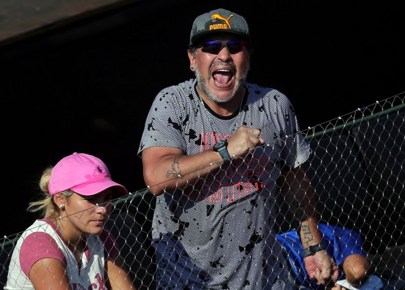 Former Argentine football star Diego Maradona cheers next to his girlfriend Rocio Oliva at the Davis Cup World Group First Round in Buenos Aires. u00e2u20acu2022 Reuters pic