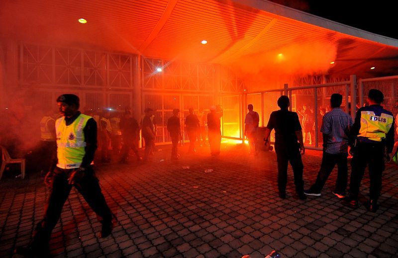 Penang football supporters light up flares after their team's Super League defeat at the State Stadium in Batu Kawan February 11, 2017. u00e2u20acu201d Bernama pic