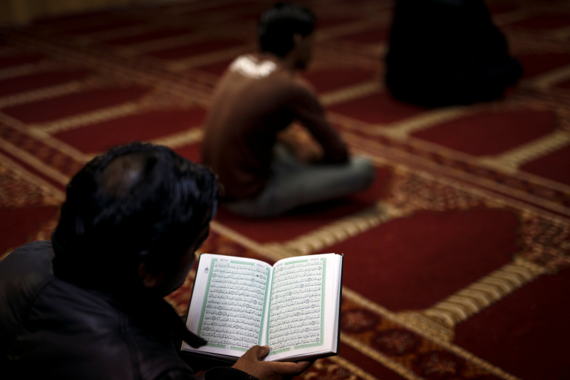A Muslim living in Greece reads the Quran before Friday prayers at the Masjid Al-Salam makeshift mosque in Athens February 3, 2017. u00e2u20acu201d Reuters pic