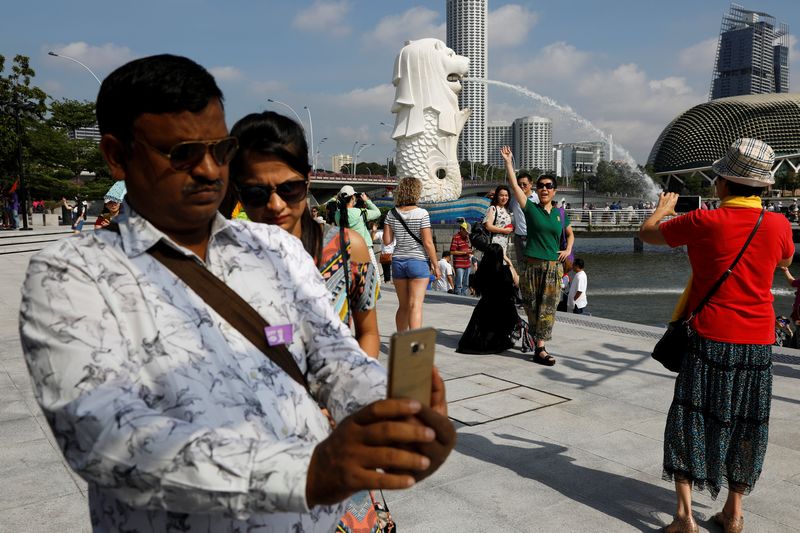 Tourists take photos at the Merlion Park in Singapore January 11, 2017. u00e2u20acu201d Reuters pic