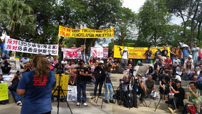 Siti Kasim speaks at a rally where the multiracial crowd holds banners in three languages to call for the rejection of the bid to increase the Shariah courts' sentencing powers and rejection of the Islamisation of Malaysia February 18, 2017. u00e2u20acu2022 Picture b