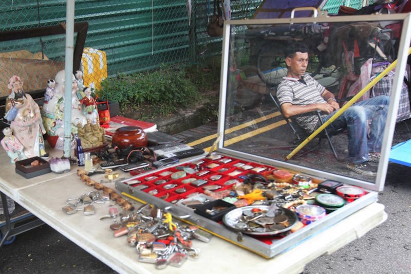 A vendor sits around on a slow weekday afternoon when foot traffic at the Thieves' Market is low. u00e2u20acu201d TODAYn