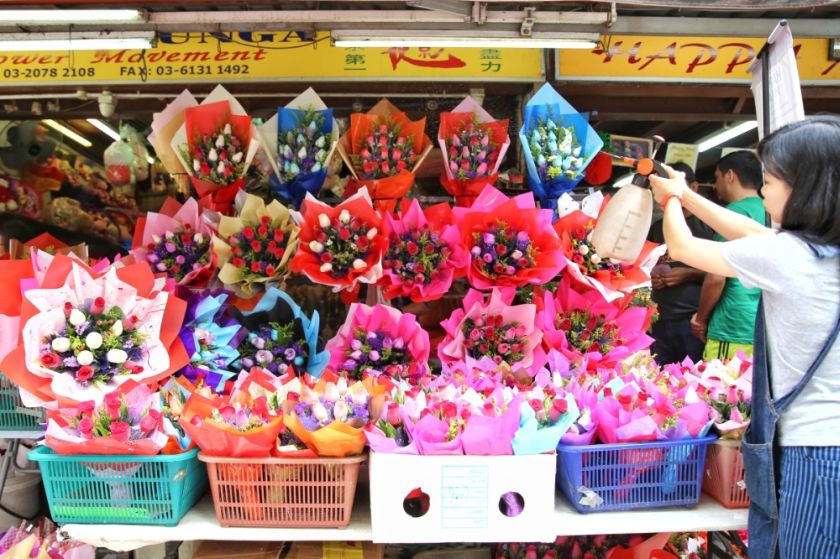 A florist is pictured watering flowers ahead of Valentine's Day on Petaling Street, Kuala Lumpur on February 13, 2017. u00e2u20acu201d Picture by Saw Siow Feng