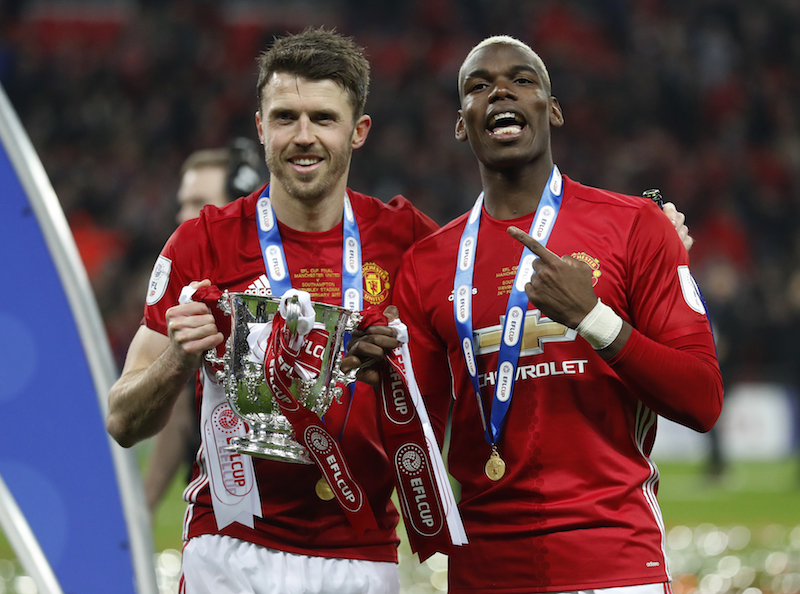 Manchester Unitedu00e2u20acu2122s Paul Pogba and Michael Carrick celebrate with the trophy after winning the EFL Cup Final against Southampton in London February 26, 2017. u00e2u20acu201d Reuters pic