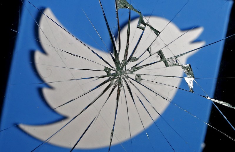 A 3D-printed Twitter logo is seen through broken glass, in this picture illustration taken February 8, 2016. u00e2u20acu201d Reuters pic