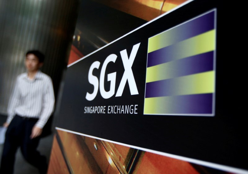 An office worker walks past a logo of the Singapore Stock Exchange (SGX) outside its premises in Singapore April 23, 2014. u00e2u20acu201d Reuters pic