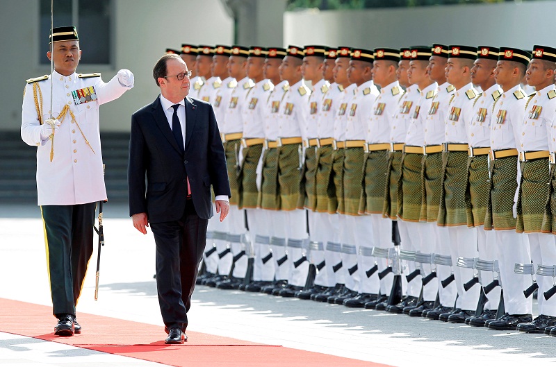 French President Francois Hollande inspects an honour guard during a welcome ceremony at the Parliament House in Kuala Lumpur March 28, 2017. u00e2u20acu201d Reuters pic