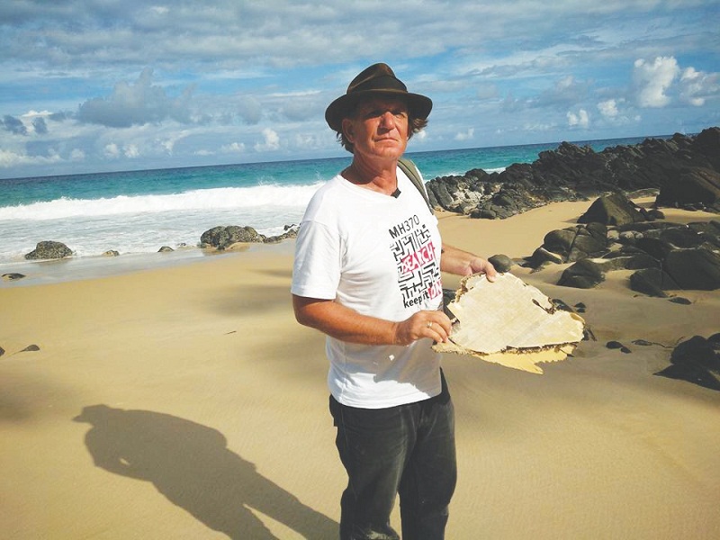 Independent investigator Blaine Alan Gibson with a piece of debris he found. He says his team will continue the search u00e2u20acu02dcquietlyu00e2u20acu2122. u00e2u20acu201d Picture by Malay Mail