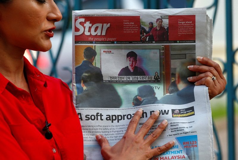 A journalist holds up a newspaper showing a photo of a man who claims to be the son of Kim Jong Nam outside the North Korean embassy in Kuala Lumpur March 9, 2017.  u00e2u20acu201d Reuters pic
