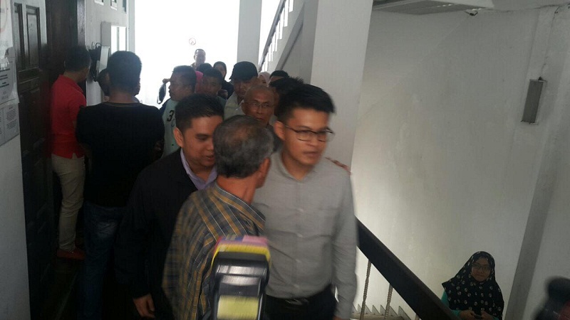 Inspector Mohd Faiz Mohd Yusof (centre, in glasses) being brought to court to be charged for accepting bribes amounting to RM3,000 in a Narcotics case in Penampang, Sabah March 9, 2017. 