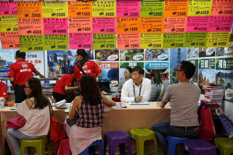 Visitors talk to staff at the Japan booth during the Matta Fair in Kuala Lumpur March 17, 2017. u00e2u20acu201d Picture by Saw Siow Feng
