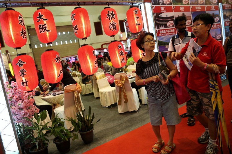 Visitors walk past a booth at the Matta Fair in Kuala Lumpur March 17, 2017. u00e2u20acu201d Picture by Saw Siow Feng